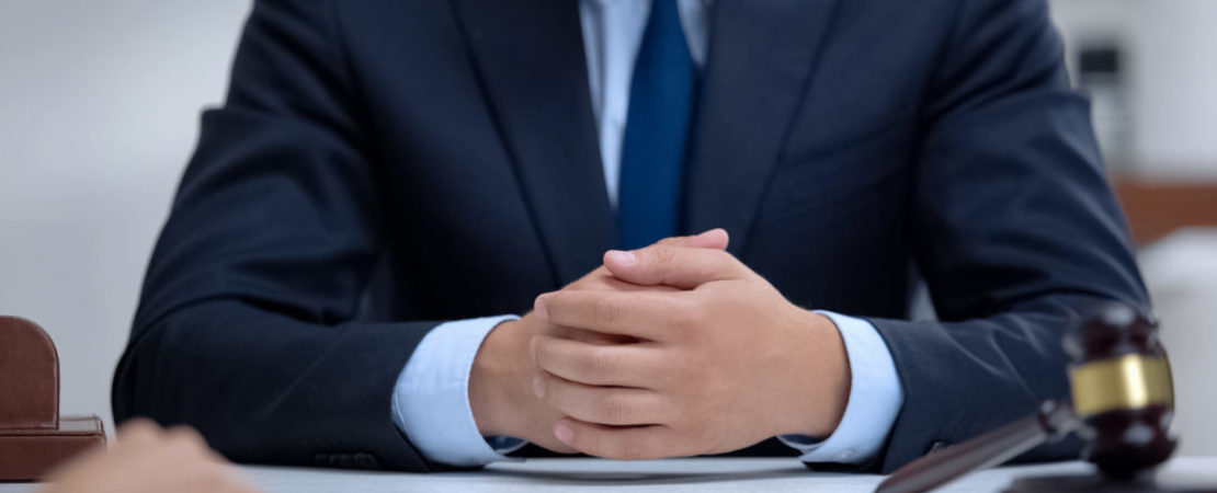 Professional lawyer carefully listening to client and giving advices, close-up